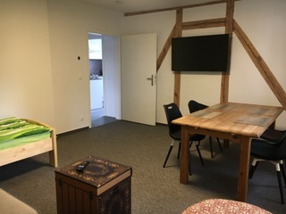 Wohnbereich mit Esstisch und Fernseher